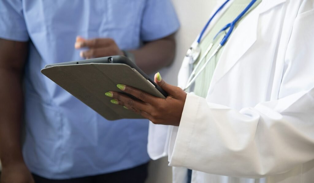 Doctor reviewing results with a patient on a tablet