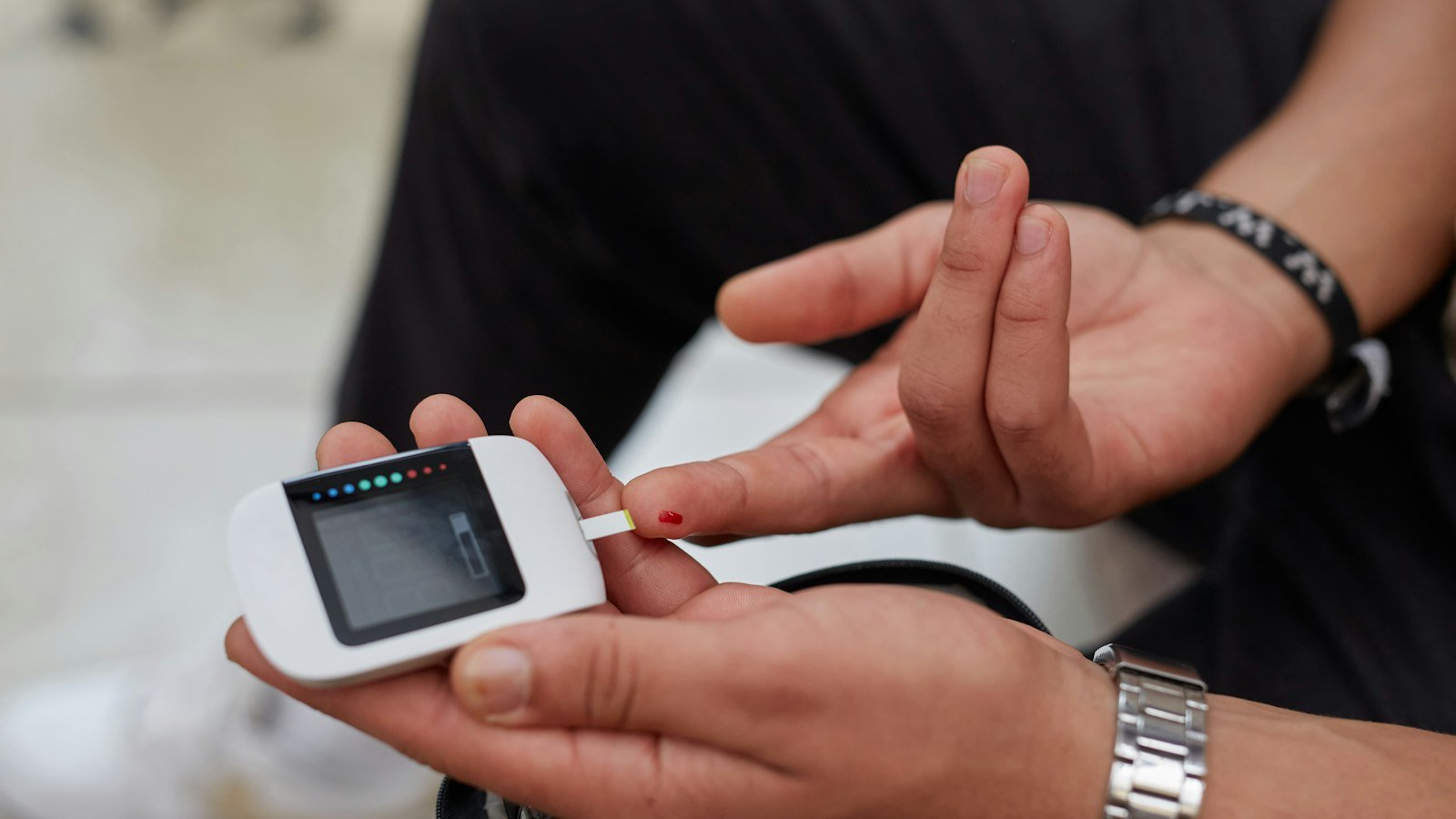 Person checking their blood sugar with a glucose meter