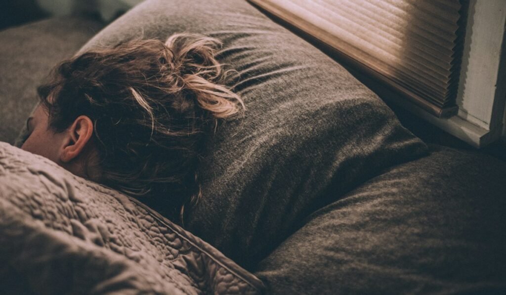 Person sleeping under blankets